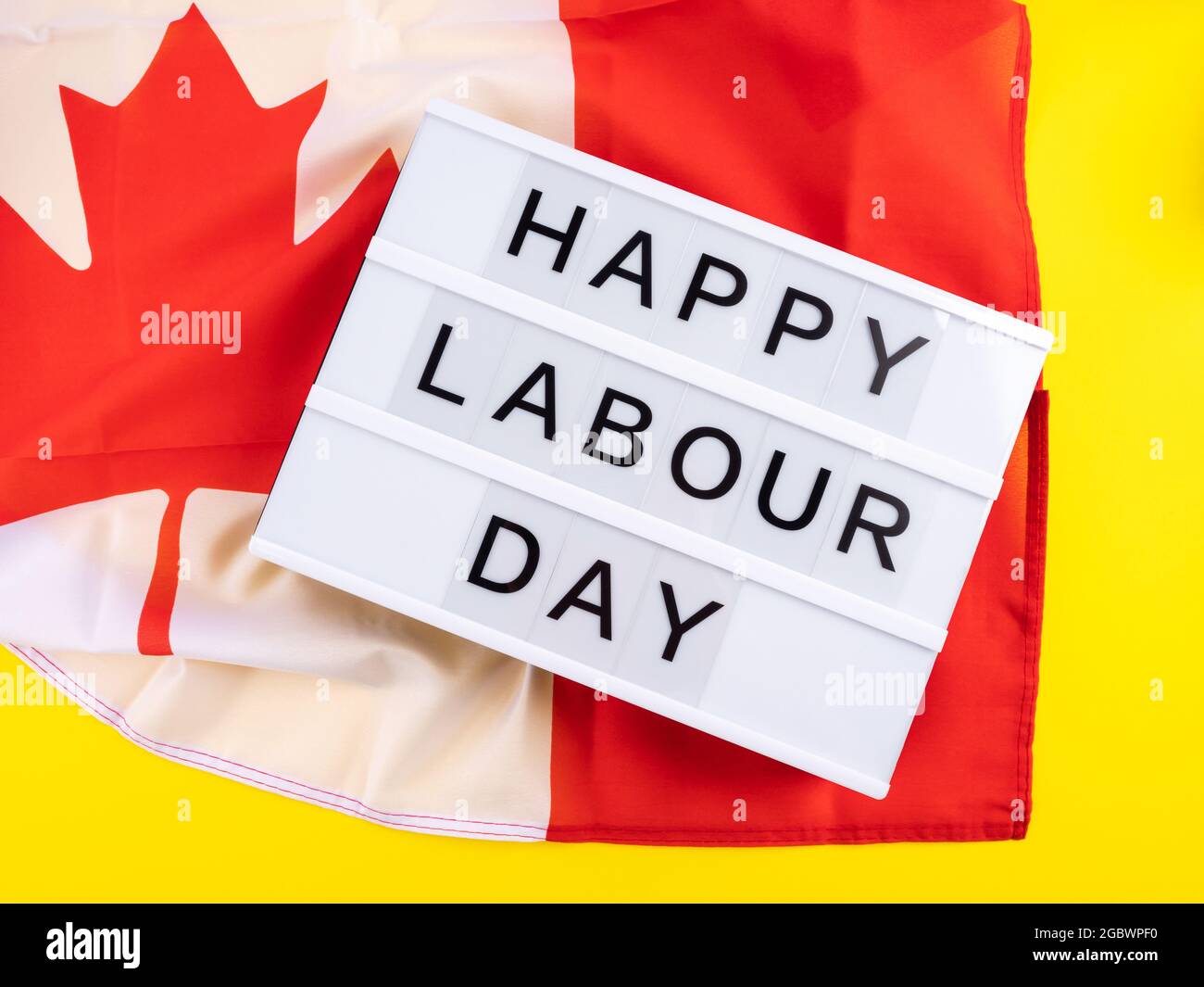 Happy Labour Day greetings on lightbox with canadian flag Stock Photo
