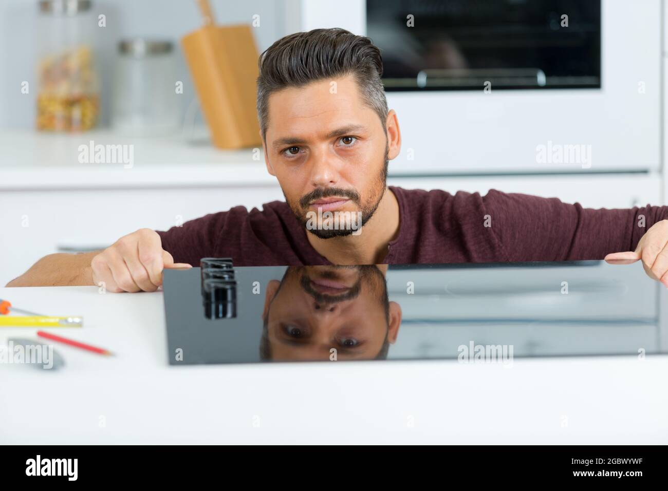 fitting a new kitchen hob Stock Photo Alamy