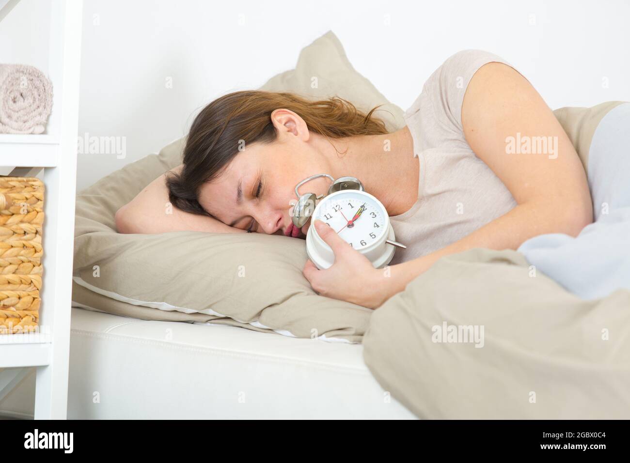 sad woman with alarm clock Stock Photo Alamy