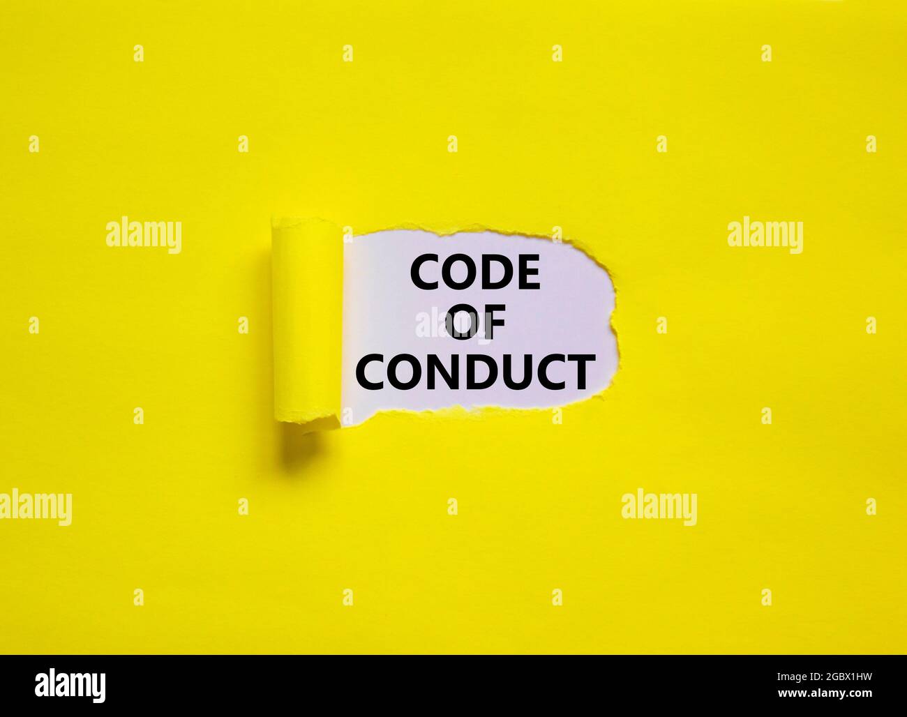 Code of conduct symbol. Words 'Code of conduct' appearing behind torn ...