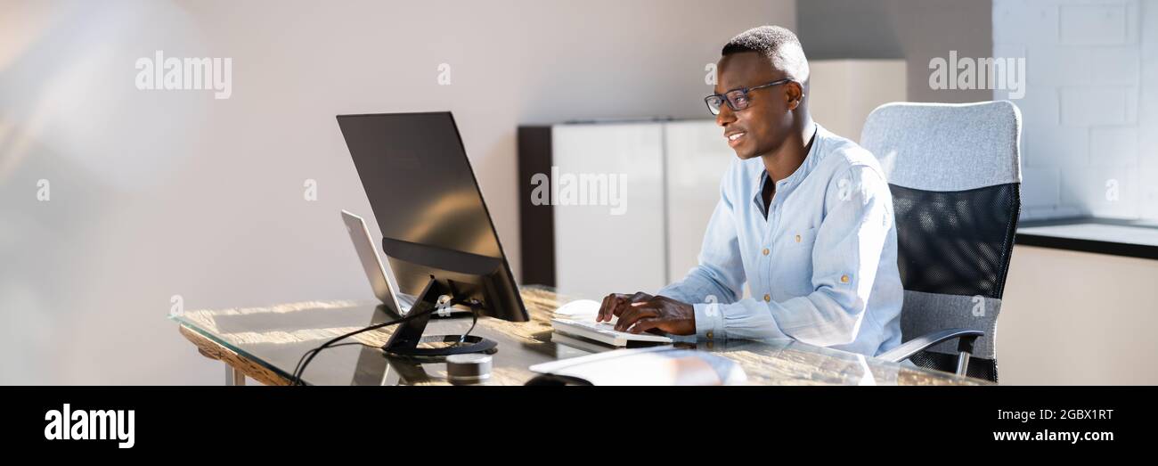 Happy Professional Man Employee Using Computer For Work Stock Photo