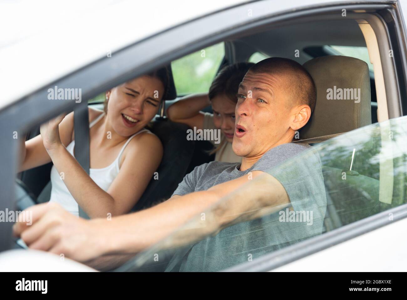 Man driver, his wife and doughter scared screaming in the car Stock Photo