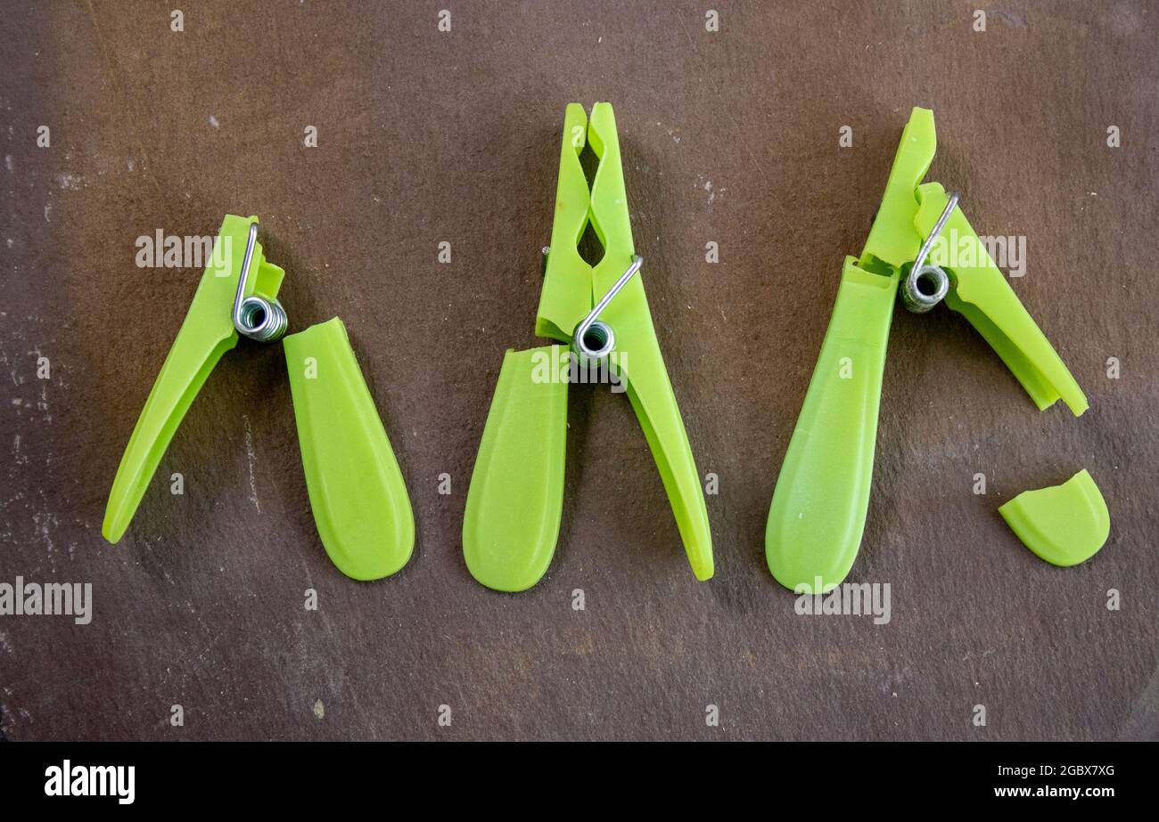 Lime green plastic clothes pegs that didn't last long Stock Photo Alamy