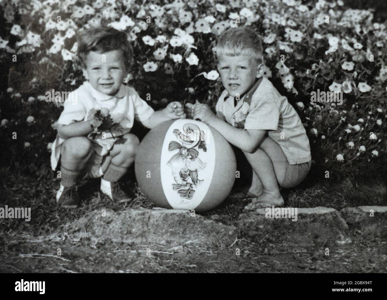 Two siblings playing with ball while on holiday. Archival photo circa 1969, Bulgaria, Eastern Europe Stock Photo