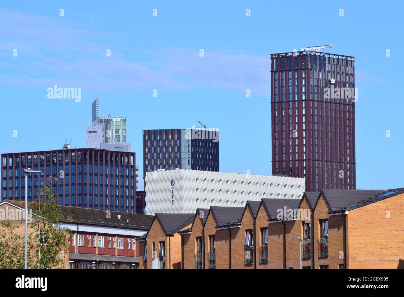 New skyscrapers or high rise buildings, with new houses in the foreground, in central Manchester, England, United Kingdom Stock Photo