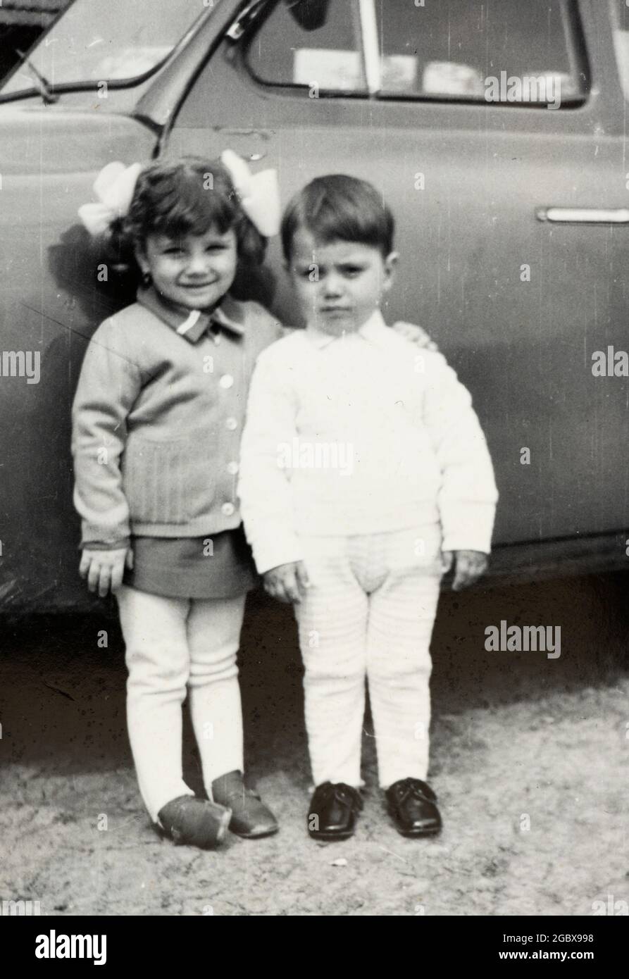 Siblings posing for photo by a car circa 1970, Bulgaria, Balkans, Europe Stock Photo