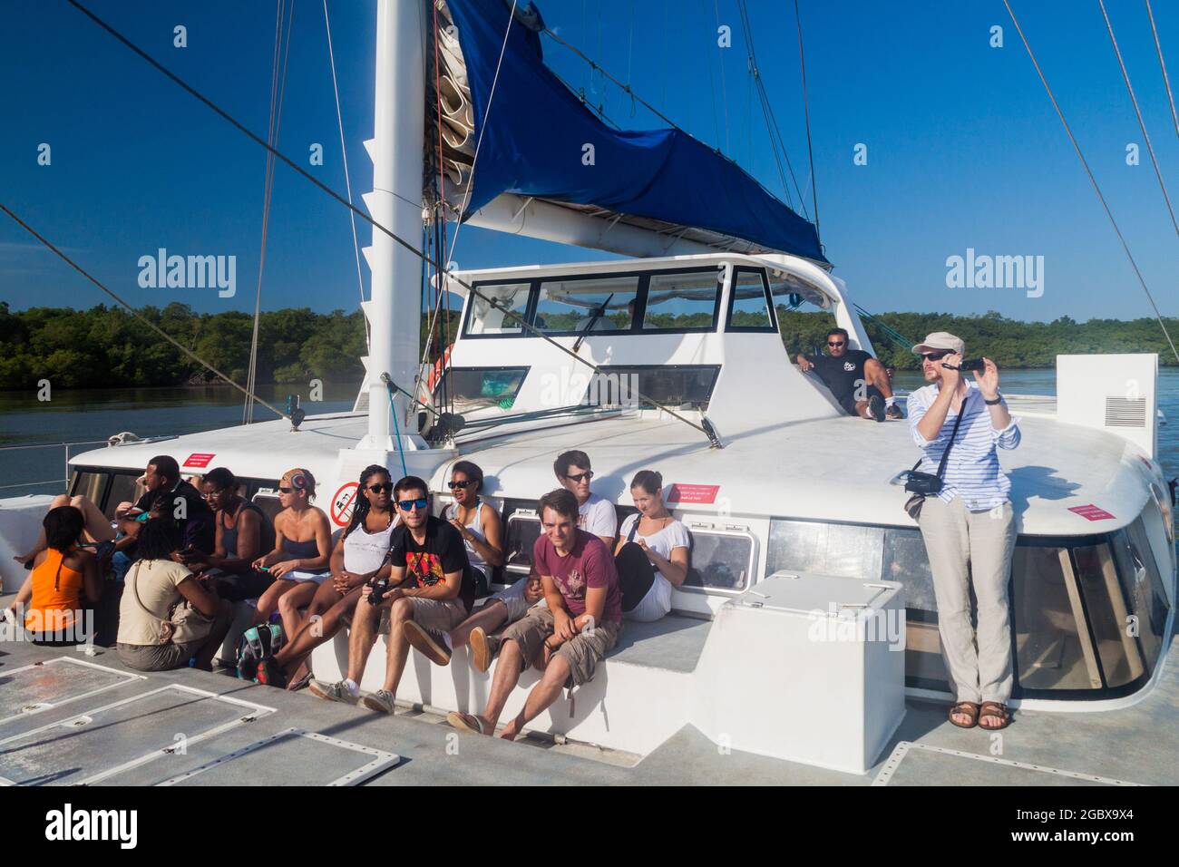 KOUROU, FRENCH GUIANA - AUGUST 2, 2015: Tourists aboard modern catamaran on their way to Iles du Salut (Islands of Salvation) in French Guiana. Stock Photo