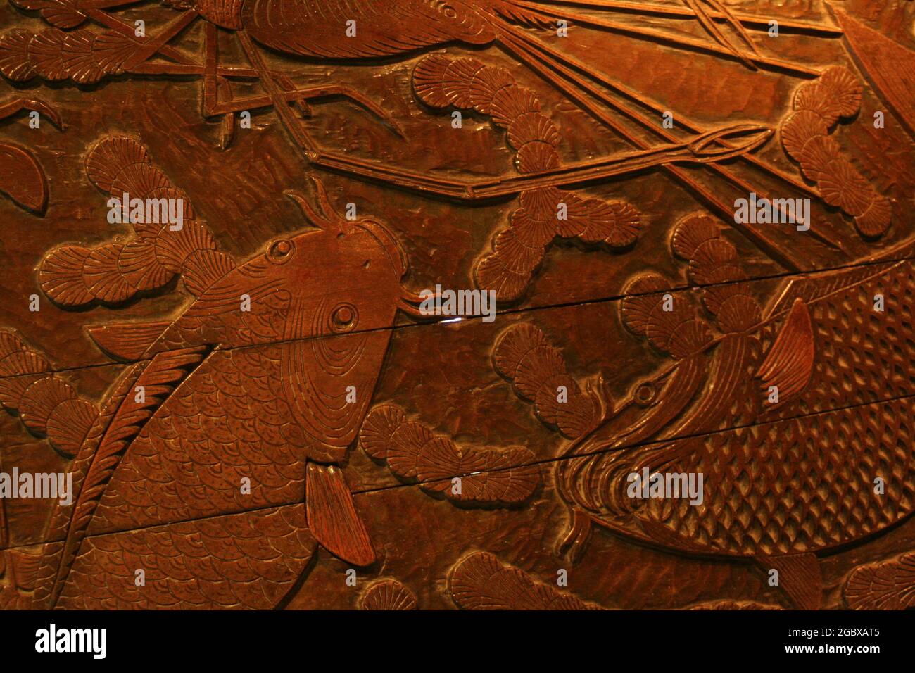 Koi carp in a woodcut block print design, Thailand Stock Photo