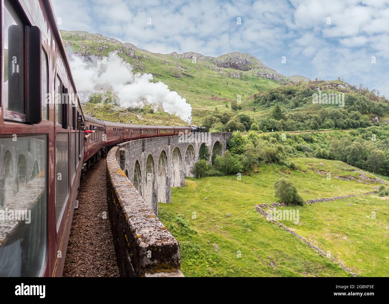 The Jacobite steam train going over Glenfinnan Viaduct, aka the 'Harry Potter bridge' as it returns of Fort William from Mallaig. West Highlands, Scotla Stock Photo