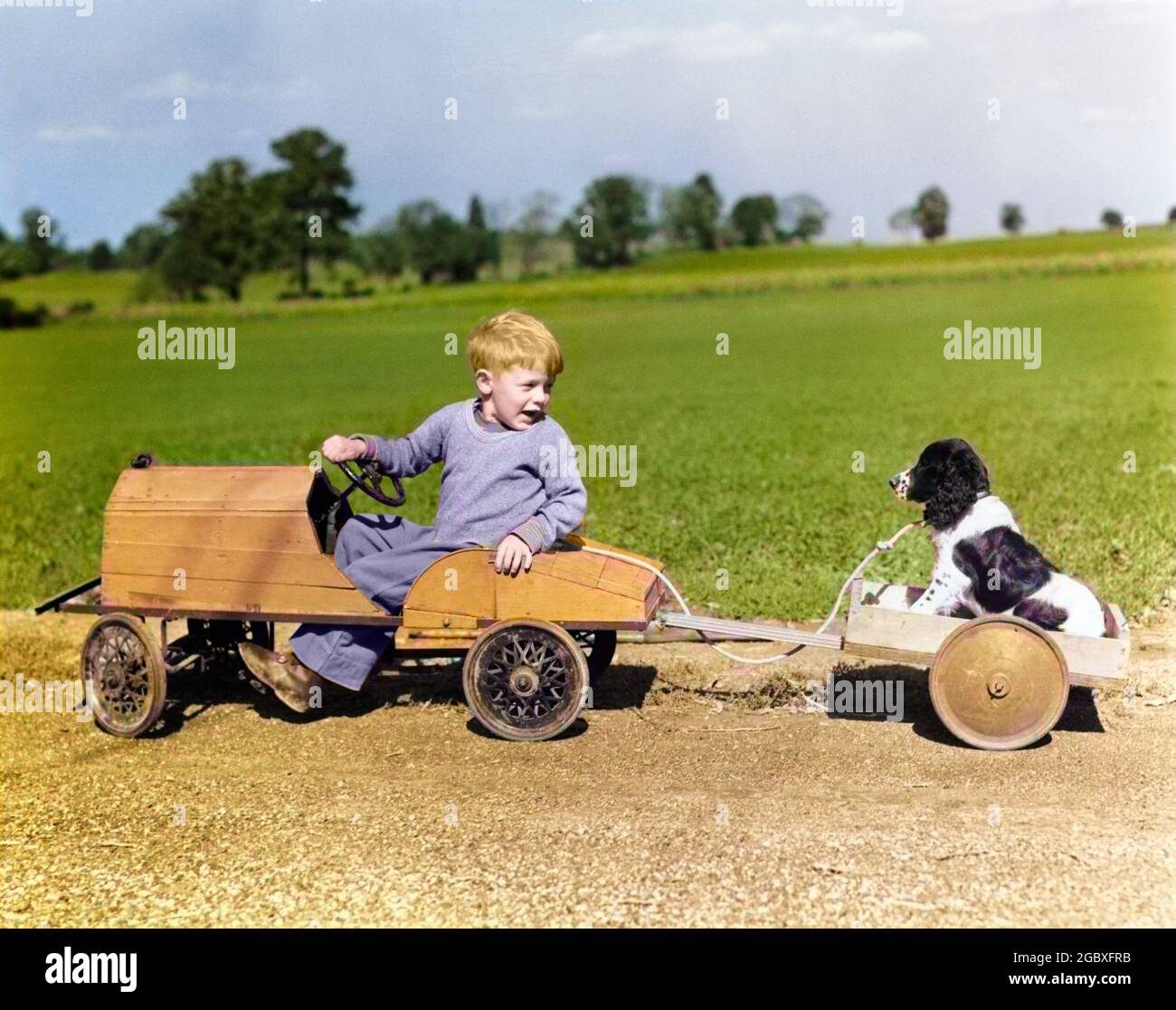 1930s 1940s BOY IN WOODEN TOY CAR PULLING DOG BEHIND IN WAGON - d421c HAR001 HARS 1 WAGON JUVENILE VEHICLE FRIEND BEST SPANIEL LIFESTYLE RURAL COPY SPACE FRIENDSHIP FULL-LENGTH PERSONS AUTOMOBILE MALES WHEELS ROD TRANSPORTATION RELEASES MAMMALS MAN'S BEST FRIEND ADVENTURE AUTOS CANINES LEADERSHIP PAL WAGON WHEELS AUTOMOTIVE MOTORING ZOOLOGY TOWING AUTOMOBILES FRIENDLY SPANIELS WAGON WHEEL WAGONS BEST FRIEND MAN'S MOTORIST ANIMALS DOG ANIMALS DOGS CANINE HOT ROD HOTROD HOTRODS JUVENILES MAMMAL PUP RODS SPRINGIER SPRINGIER SPANIEL SPRINGIER SPANIELS TOGETHERNESS YOUNGSTER BUDDY Stock Photo