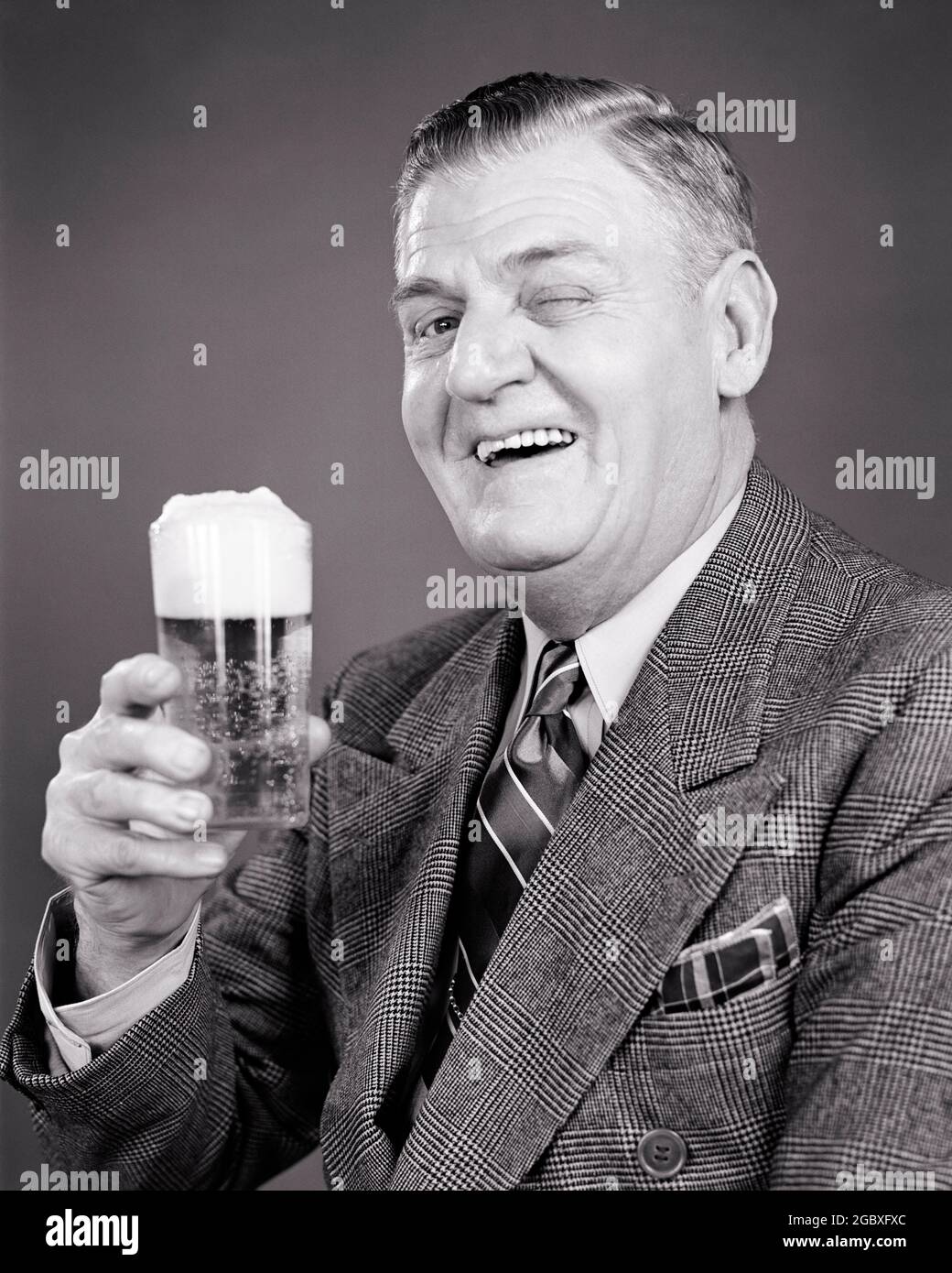 1940s laughing older man in suit and tie looking at camera winking lifting a glass of beer with a good foamy head in a toast f655 har001 hars 1 lifting welcome 1940s laughing older man in suit and tie looking at camera winking lifting a glass of beer with a good foamy head in a toast f655 har001 hars 1 lifting welcome