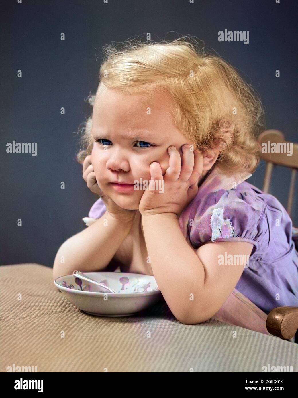 1940s GIRL AT TABLE WITH HEAD CRADLED IN BOTH HANDS FROWN ON HER FACE A CEREAL BOWL AND SPOON BETWEEN HER ELBOWS ON TABLE - f9812c HAR001 HARS WORRY CEREAL GRAIN ANNOYED FEMALES STUDIO SHOT MOODY PORTRAITS COPY SPACE FROWN THOUGHTFUL BOWLS EXPRESSIONS TROUBLED FOODS CONCERNED FROWNING SADNESS THOUGHT HUNGRY HEAD AND SHOULDERS NOURISH BOTH DISTRESSED MANUAL IRATE SHE BETWEEN HUNGER MOOD BREAKFAST FOOD ELBOWS GLUM NOURISHMENT DISPLEASURE HOSTILITY BREAKFAST FOODS CEREAL BOWL CEREAL BOWLS HAS ANNOYANCE CRADLED DISGRUNTLED EMOTION EMOTIONAL GRAINS IRRITATED JUVENILES MISERABLE YOUNGSTER Stock Photo