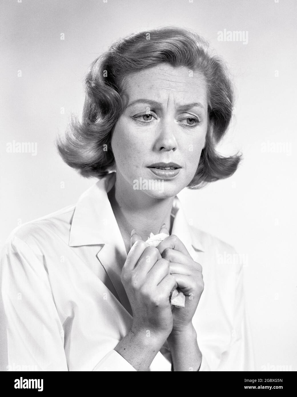 1950s 1960s PORTRAIT CONCERNED WORRIED WOMAN CLUTCHING TISSUE  - g4578 HAR001 HARS HALF-LENGTH LADIES PERSONS CARING CRY HEADACHE EXPRESSIONS TROUBLED B&W CONCERNED SADNESS HEALTHCARE ANXIETY PREVENTION ALLERGY TISSUE HEALING DIAGNOSIS HEALTH CARE IMPAIRMENT MOOD SORROW TREATMENT MOURNING ALLERGIES CONCEPTUAL GLUM REGRET GRIEF MID-ADULT MID-ADULT WOMAN MISERABLE SINUS BLACK AND WHITE CAUCASIAN ETHNICITY CLUTCHING DISEASE DOWNCAST HAR001 OLD FASHIONED Stock Photo