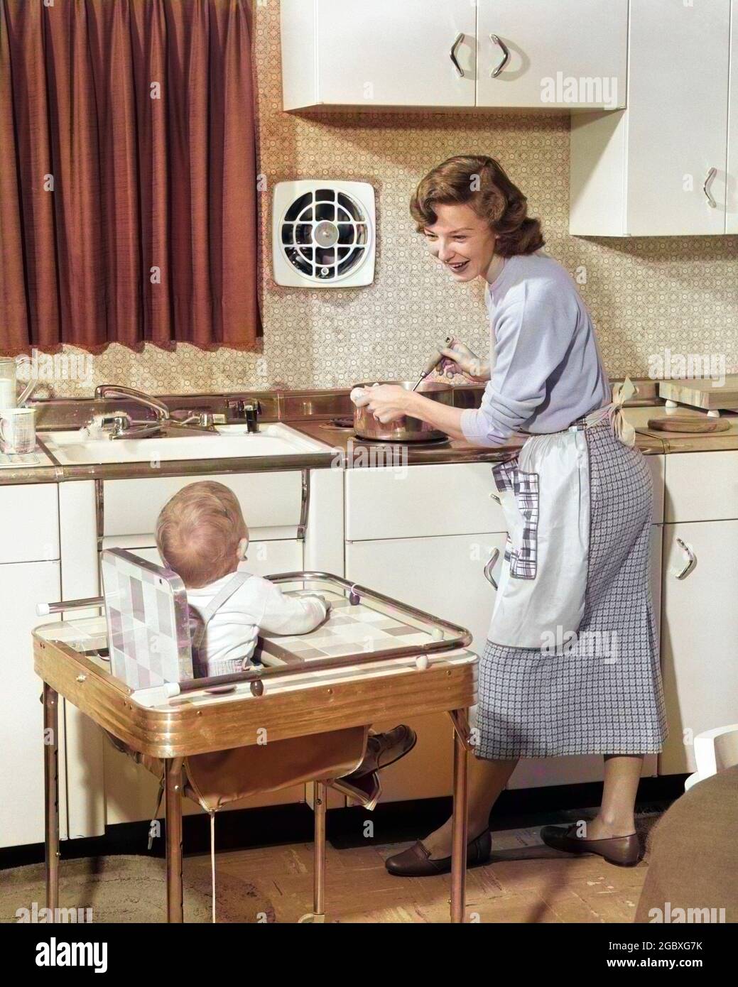 1950s WOMAN MOTHER IN HOME KITCHEN COOKING POT ON STOVE SMILING AT BABY CHILD IN HIGH CHAIR - h1665c HAR001 HARS TOGETHER INDOOR BABIES FURNITURE MOM STORY INDOORS POT STOVE NOSTALGIC COOK PAIR COLOR RELATIONSHIP MOTHERS CHEFS OLD TIME NOSTALGIA CHAIRS OLD FASHION 1 HOUSEHOLD JUVENILE YOUNG ADULT INFANT SONS LIFESTYLE PARENTING FEMALES RELATION GROWNUP HEALTHINESS HOME LIFE PREPARING COPY SPACE FRIENDSHIP FULL-LENGTH HALF-LENGTH LADIES DAUGHTERS PERSONS GROWN-UP CARING MALES INGREDIENTS UTENSILS SINGLE PARENT HOMEMAKER SINGLE PARENTS PEOPLE STORY MATERNAL HAPPINESS HIGHCHAIR HOMEMAKERS NOURISH Stock Photo