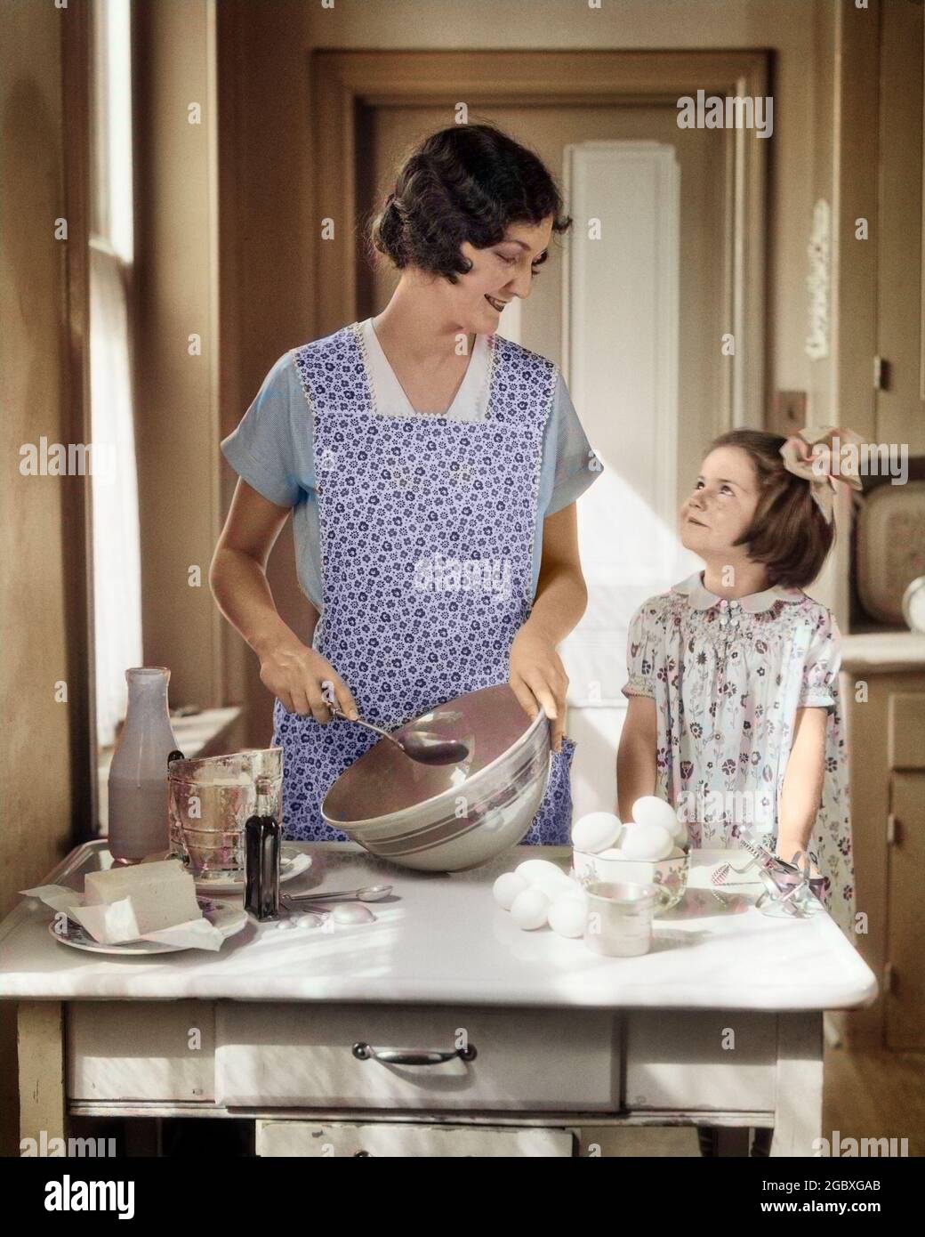 https://c8.alamy.com/comp/2GBXGAB/1920s-1930s-mother-with-mixing-bowl-in-kitchen-baking-with-daughter-h2535c-har001-hars-color-relationship-mothers-old-time-teaching-nostalgia-old-fashion-1-household-juvenile-style-mixing-pleased-joy-females-grownup-home-life-half-length-ladies-daughters-persons-grown-up-caring-ingredients-people-story-happiness-cheerful-stirring-smiles-joyful-stylish-juveniles-mid-adult-woman-moms-youngster-caucasian-ethnicity-har001-old-fashioned-2GBXGAB.jpg