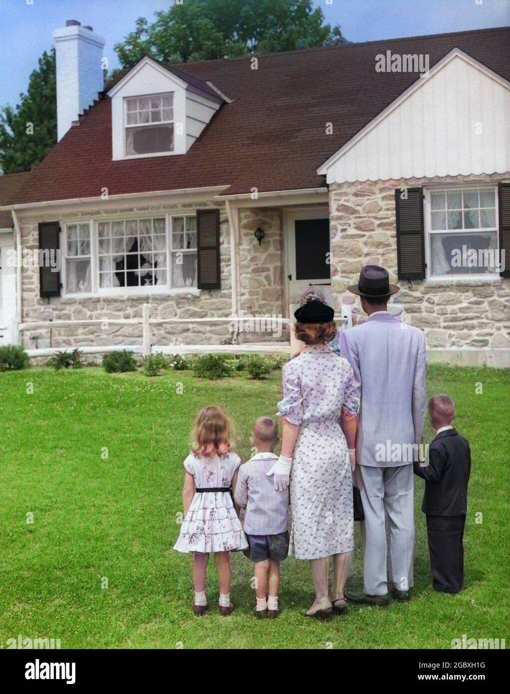 1950s FAMILY OF FIVE WITH BACKS TO CAMERA ON LAWN LOOKING AT FIELDSTONE SUBURBAN HOUSE - j7145c HAR001 HARS FIGURE YOUTH CLASSIC SINGLE LIFE OUTDOORS THREE HOUSEWIFE ALONE WIFE LAWN OUTDOOR TOGETHER HUSBAND 3 SALES DAD STAND MOM STORY LOOK NOSTALGIC PAIR FIRST STONE SUBURBAN COLOR RELATIONSHIP MOTHERS EXECUTIVE OLD TIME FUTURE NOSTALGIA BROTHER ESTATE OLD FASHION SISTER 1 JUVENILE SONS FAMILIES LIFESTYLE FIVE PARENTING FEMALES MARRIED 5 BROTHERS RELATION SPOUSE HUSBANDS HOME LIFE PEOPLE CHILDREN FULL-LENGTH DAUGHTERS INSPIRATION BUY MALES SIBLINGS AMERICANA SISTERS START FATHERS Stock Photo