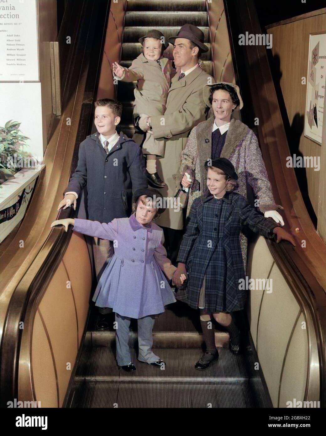 1950s SMILING FAMILY OF 6 IN WINTER COATS GOING DOWN STORE ESCALATOR - j7705c HAR001 HARS DOWN HUSBAND 3 DAD INDOOR RIDING MOM HATS INDOORS NOSTALGIC PAIR GOING COLOR RELATIONSHIP MOTHERS OLD TIME FIGURES NOSTALGIA BROTHER MOVING OLD FASHION SISTER 1 STAIRS JUVENILE RIDE SONS FAMILIES LIFESTYLE GROWNUPS PARENTING FEMALES BROTHERS RELATION SPOUSE HUSBANDS GROWNUP COATS HEALTHINESS 6 FULL-LENGTH LADIES DAUGHTERS PERSONS GROWN-UP MALES SIX PAIRS MECHANICAL SIBLINGS SISTERS FATHERS MEN AND WOMEN PATERNAL PRETEEN BOY RIDER SPOUSES FATHERHOOD MATERNAL HAPPINESS RIDERS DADS IN OF PRETEEN Stock Photo