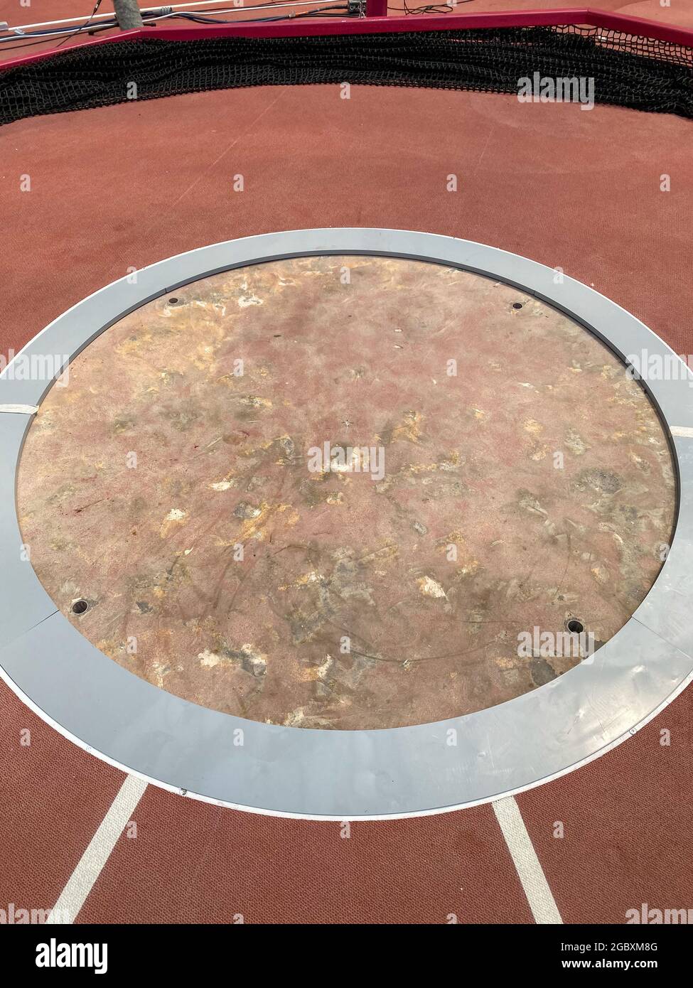 Athletics throwing circle in a stadium with silver inlet to reduce the