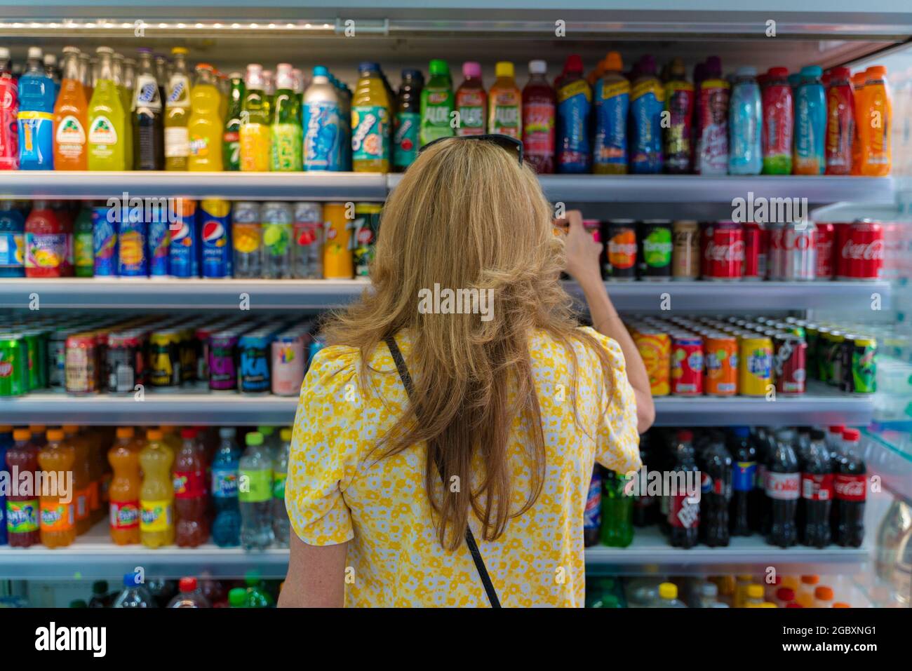 Woman Choosing Soft Drinks Stock Photo