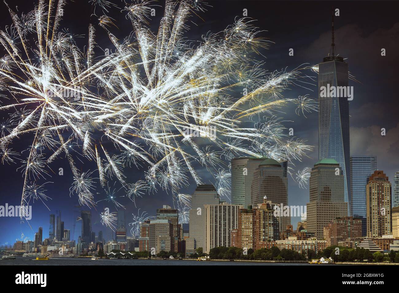 Firework over city at night with Fireworks over Manhattan Stock Photo