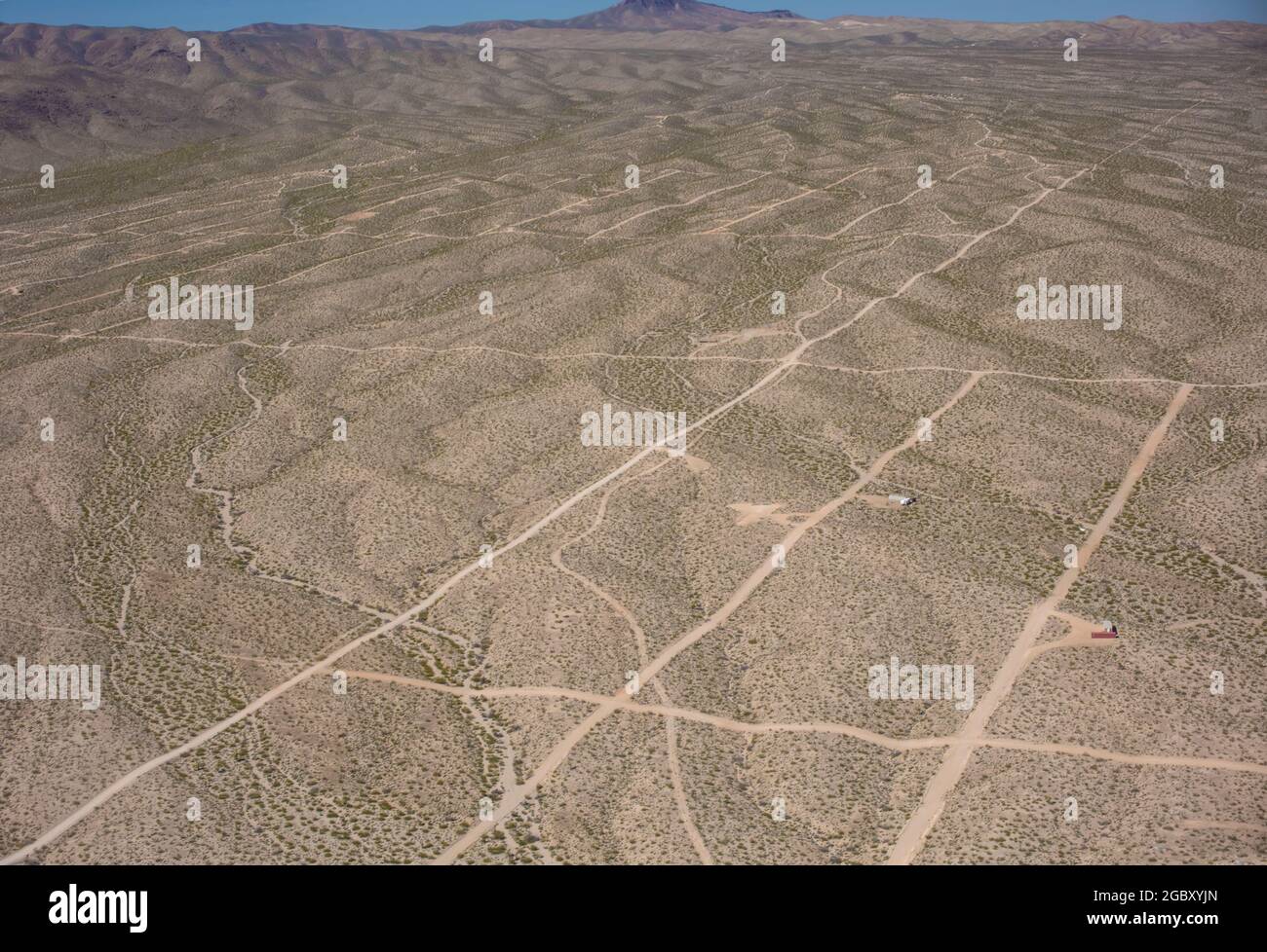 Dirt roads in grid-line configuration mark out a proposed new settlement in the desert near Las Vegas, Nevada, USA with few takers Stock Photo
