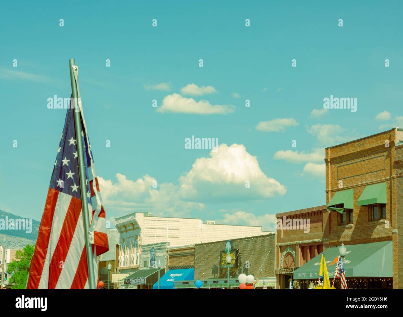 Flag waving on July parade day for the Fourth of July celebration in a small western town of Cody, Wyoming. There is room for a text message. Stock Photo
