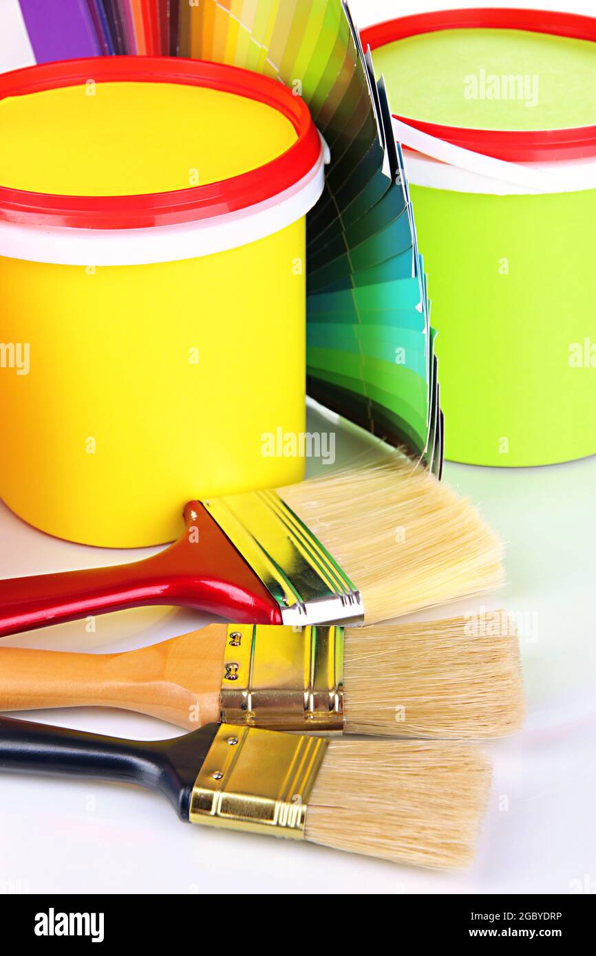 Set for painting paint pots, brushes, palette of colors close up Stock