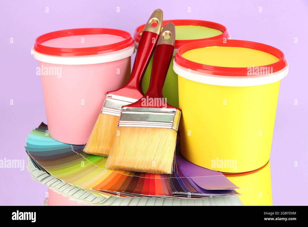 Set for painting paint pots, brushes, palette of colors on lilac