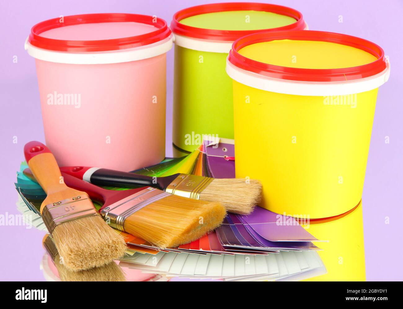 Set for painting paint pots, brushes, palette of colors on lilac