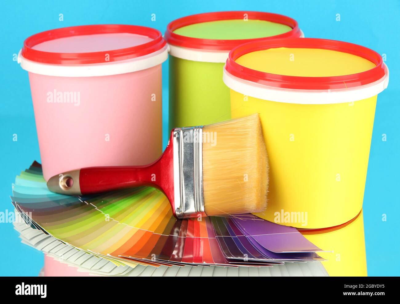 Set for painting paint pots, brushes, palette of colors on blue