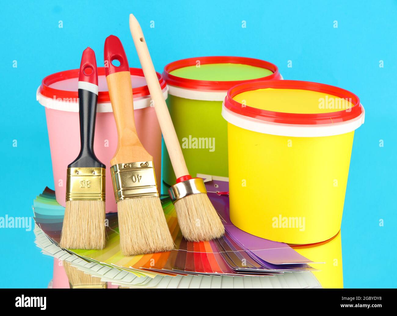 Set for painting paint pots, brushes, palette of colors on blue