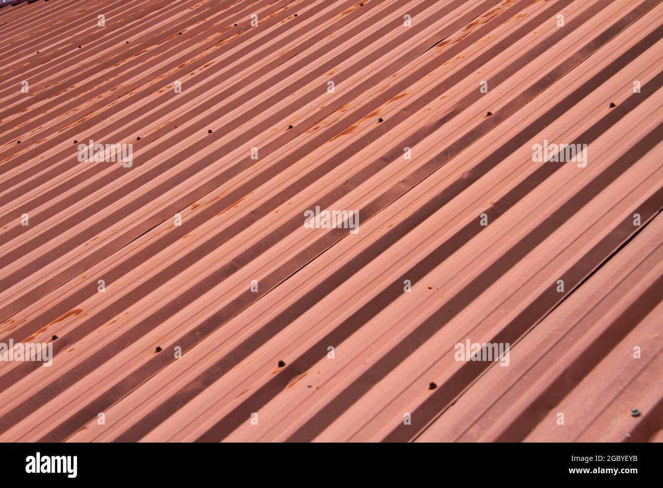 Old red metal sheet roof texture. Pattern of old red metal sheet Stock