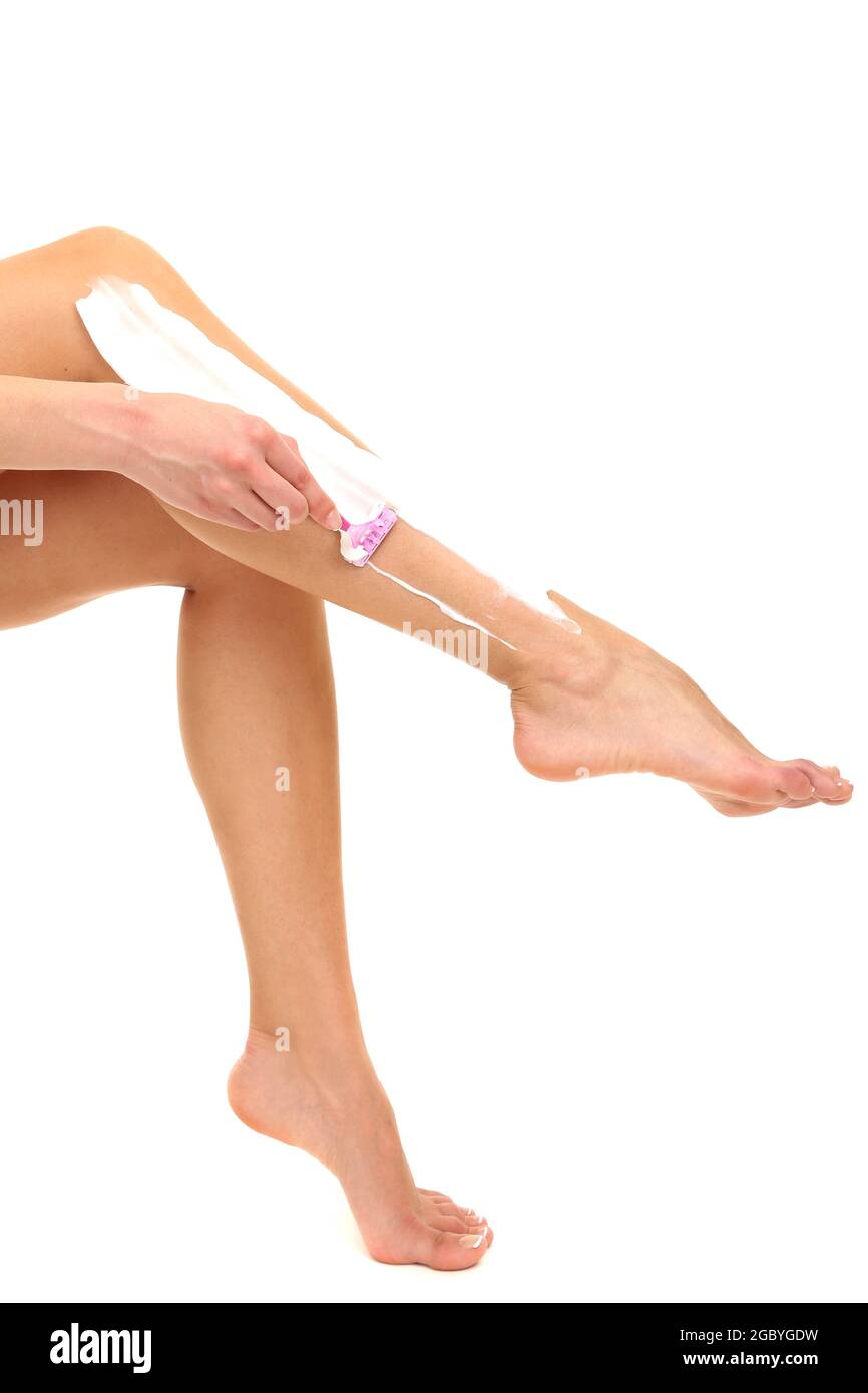 Beautiful woman is shaving her leg, isolated on white Stock Photo Alamy