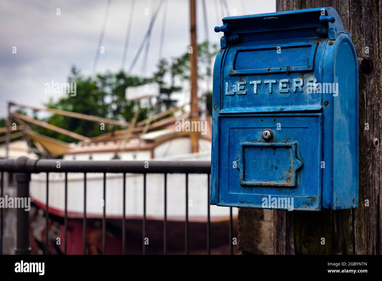 An old fashioned US Post Office mail box hangs on a telephone in Osaka, Japan. Stock Photo