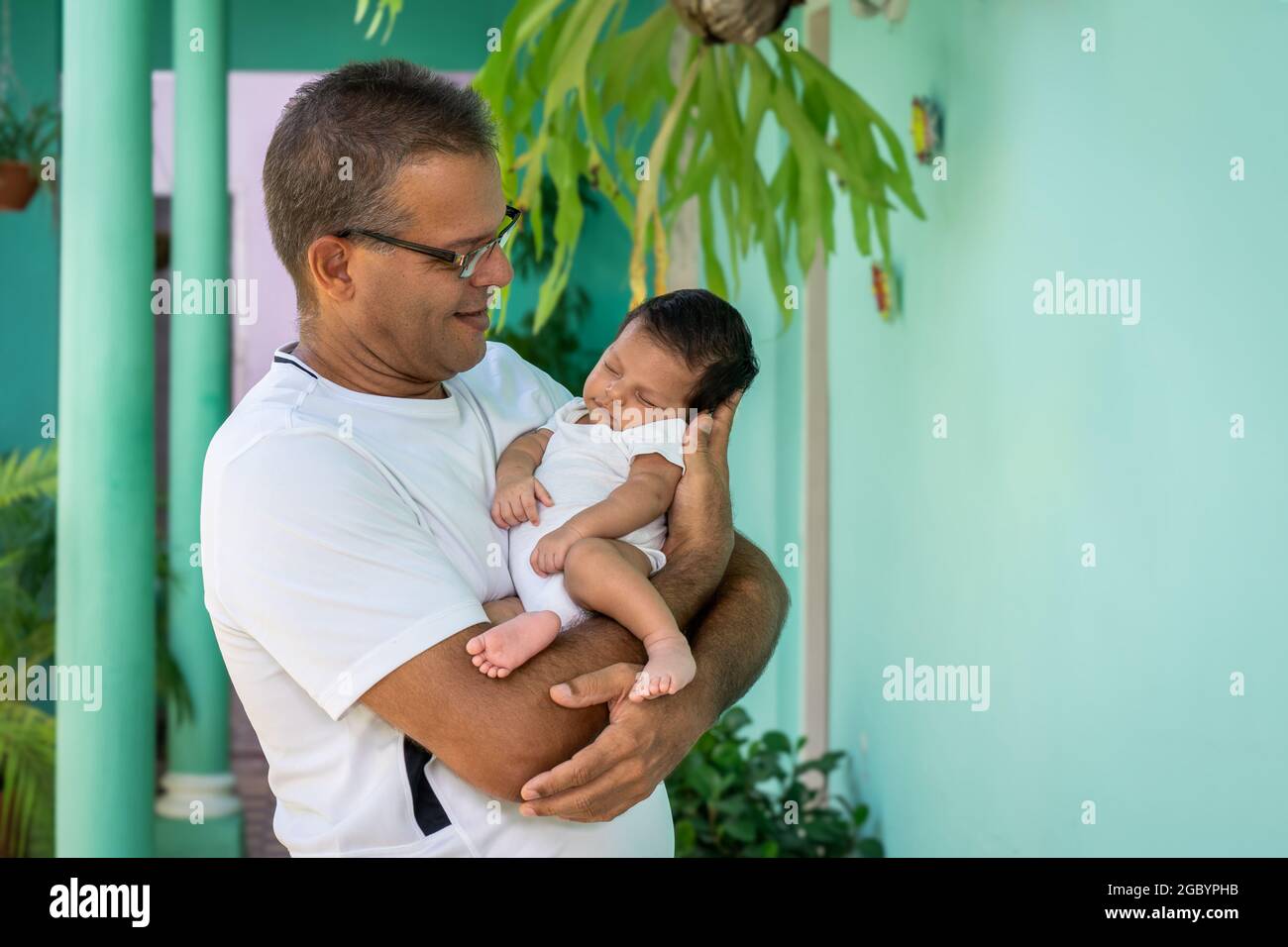 Photo of a baby in the arms of a man Stock Photo
