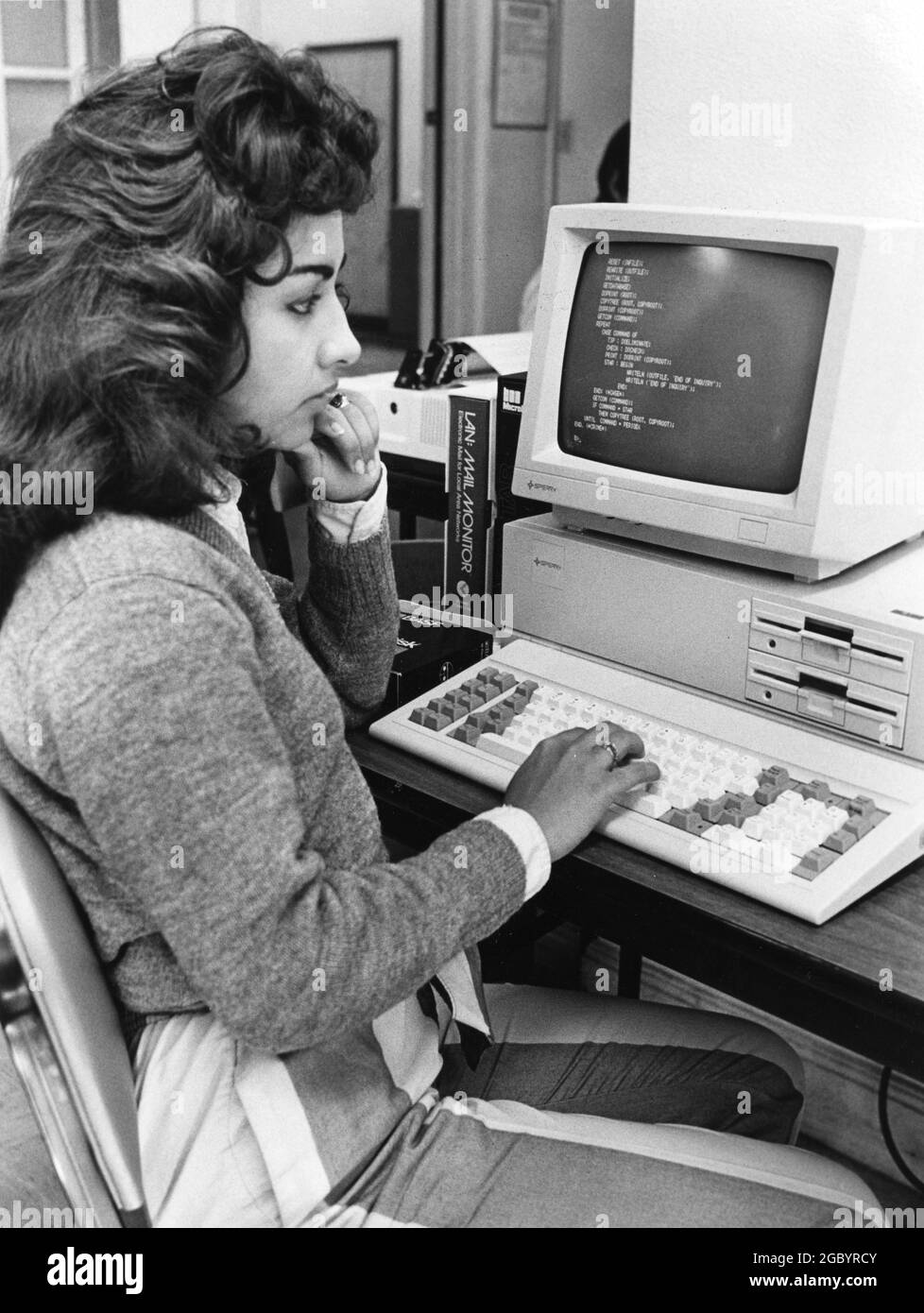 Austin Texas USA, circa 1990: Female Hispanic college student learning COBOL computer programming. ©Bob Daemmrich Stock Photo
