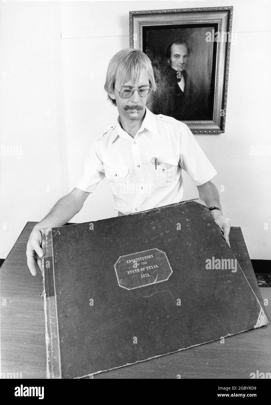Austin Texas USA, circa 1987: Researcher looking at the original handwritten 1876 Texas Constitution, housed in the State Archives collection. Stock Photo