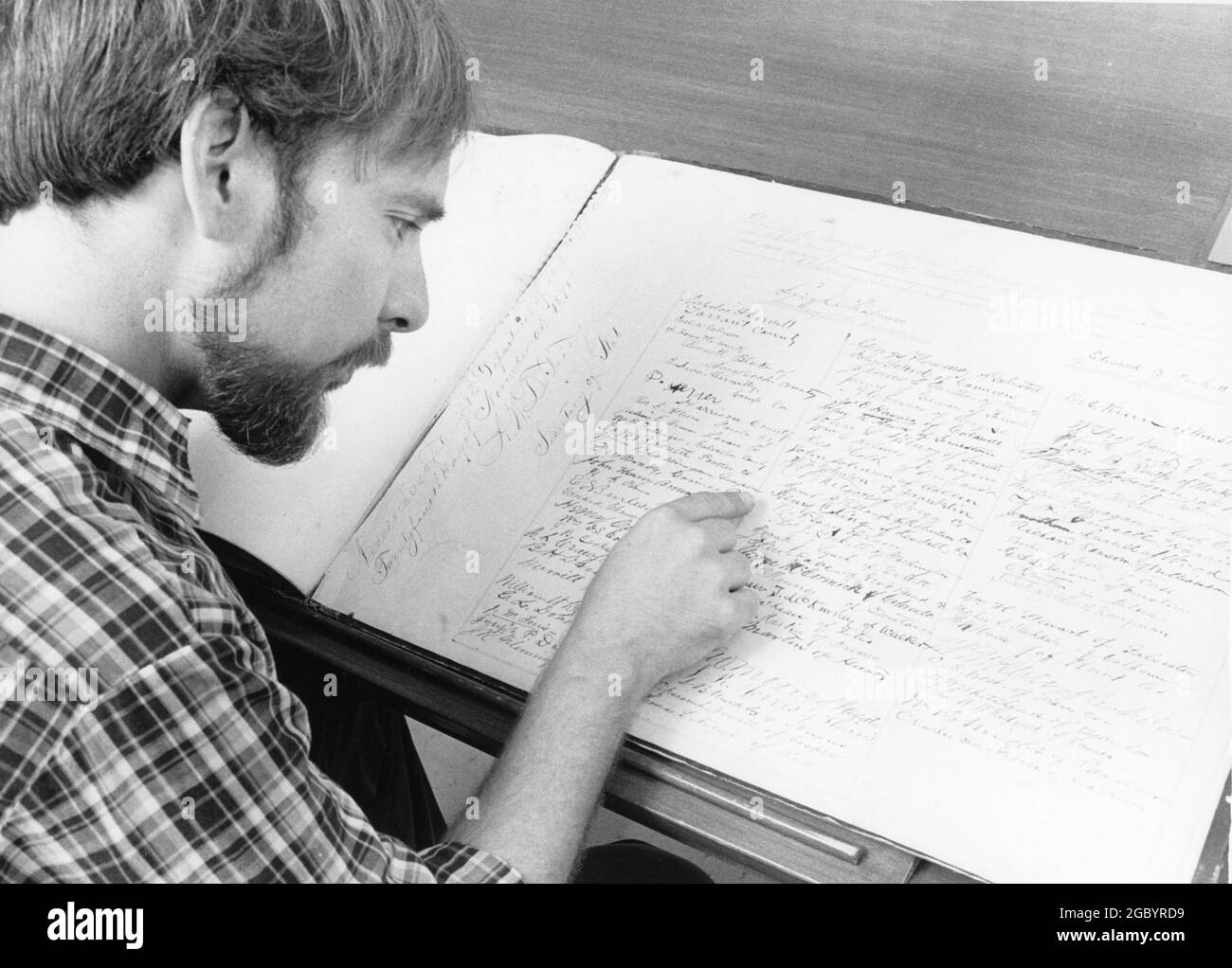 Austin Texas USA, circa 1987: Researcher looking at the original handwritten 1876 Texas Constitution, housed in the State Archives collection. Stock Photo