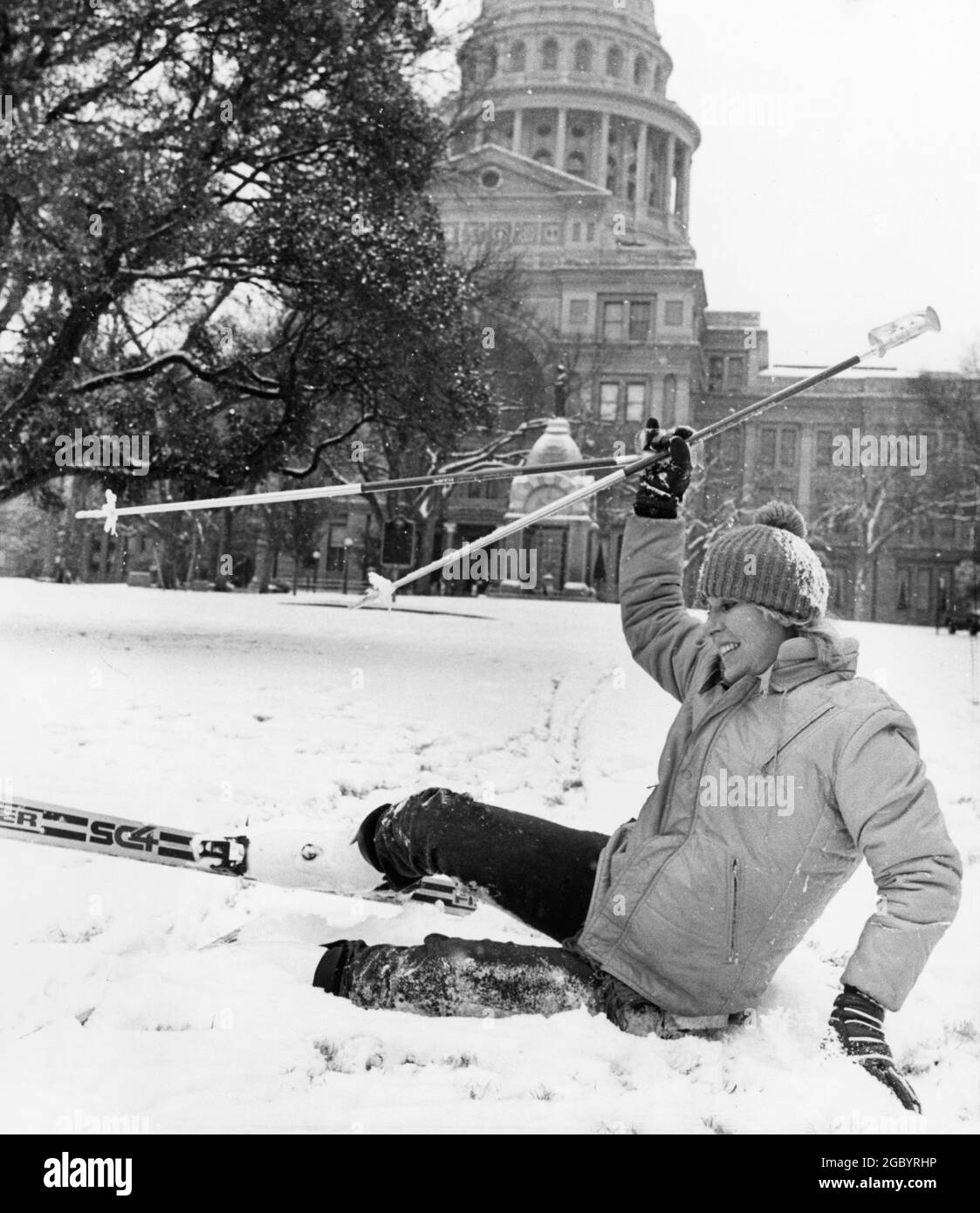 Austin Texas USA, Jan. 2, 1985: Woman takes a tumble trying to ski on the Capitol grounds after a rare snowfall. ©Bob Daemmrich Stock Photo