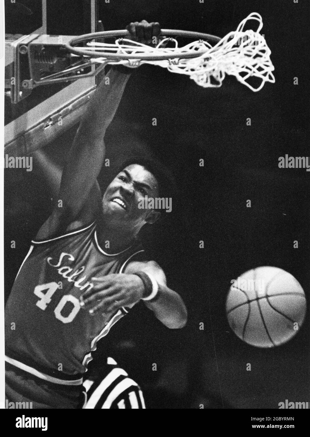 Austin Texas USA, circa 1986: Basketball player makes a slam dunk during the boys high school state basketball tournament finals. ©Bob Daemmrich Stock Photo