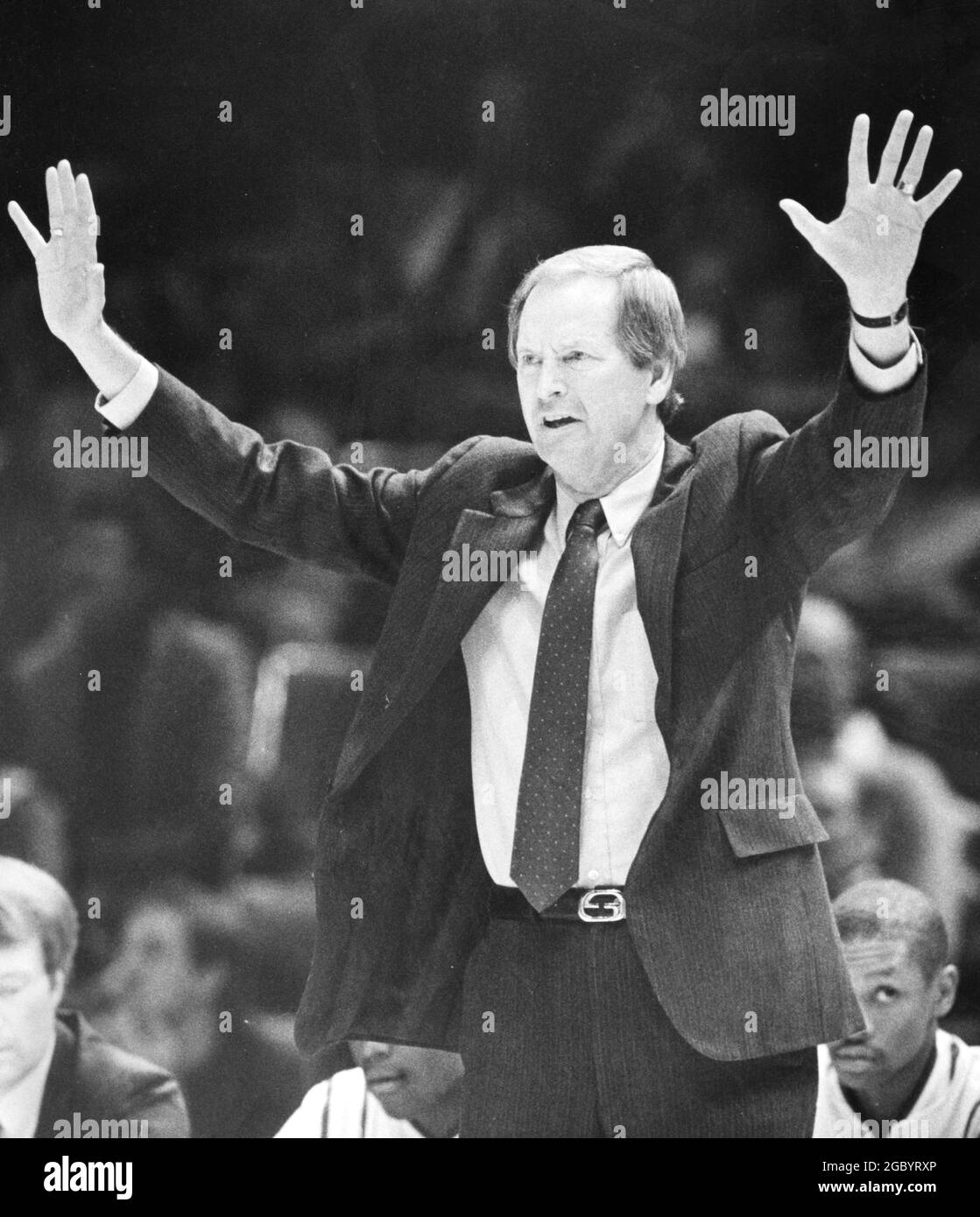 Austin Texas USA, circa 1986: Male high school basketball coach signals his team from the sidelines during a boys' state tournament championship finals game. ©Bob Daemmrich Stock Photo