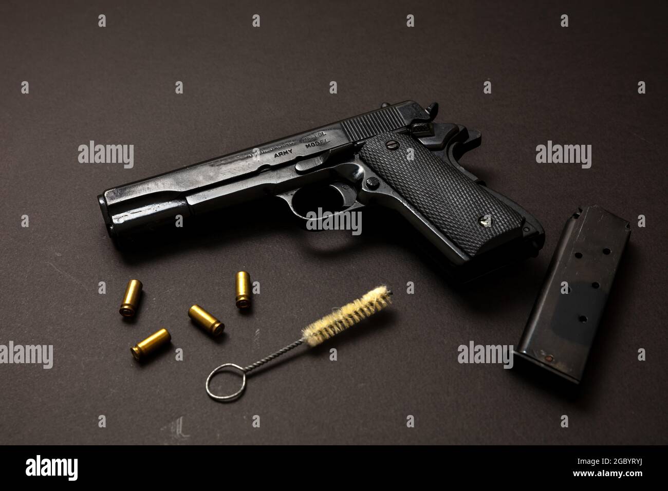 Gun pistol 9mm, magazine, ammo bullet shells and cleaning rod on black