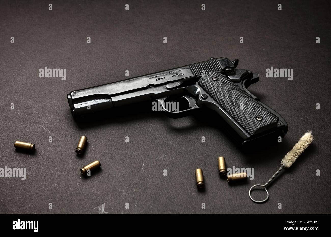 Pistol gun 9mm, magazine, ammo bullet shells and cleaning rod on black