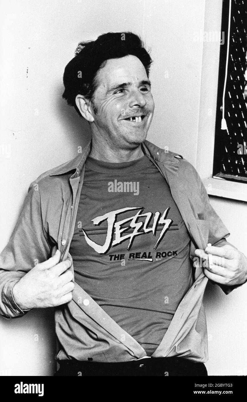 Georgetown Texas USA,1984: Convicted murderer Henry Lee Lucas shows off his 'Jesus' t-shirt during a jailhouse interview in the Williamson County jail. ©Bob Daemmrich Stock Photo