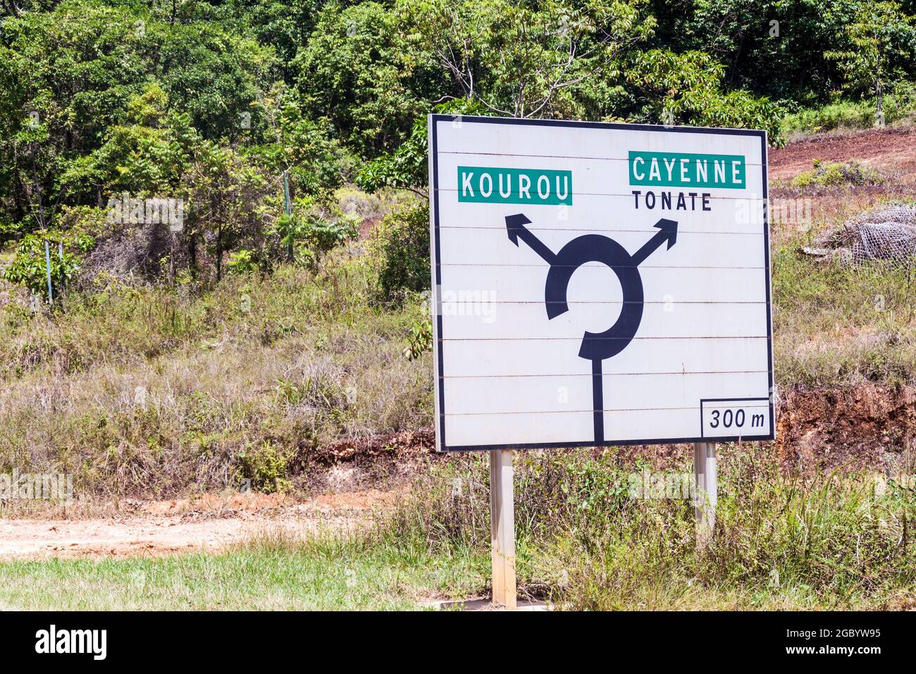 Roadsign at a roundabout pointing to Cayenne and Kourou, French Guiana Stock Photo