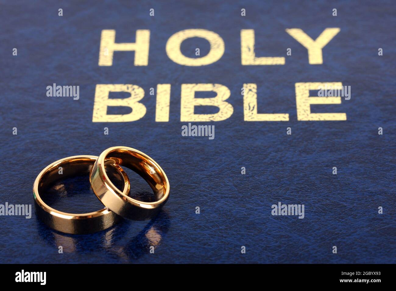 Wedding rings on bible Stock Photo Alamy