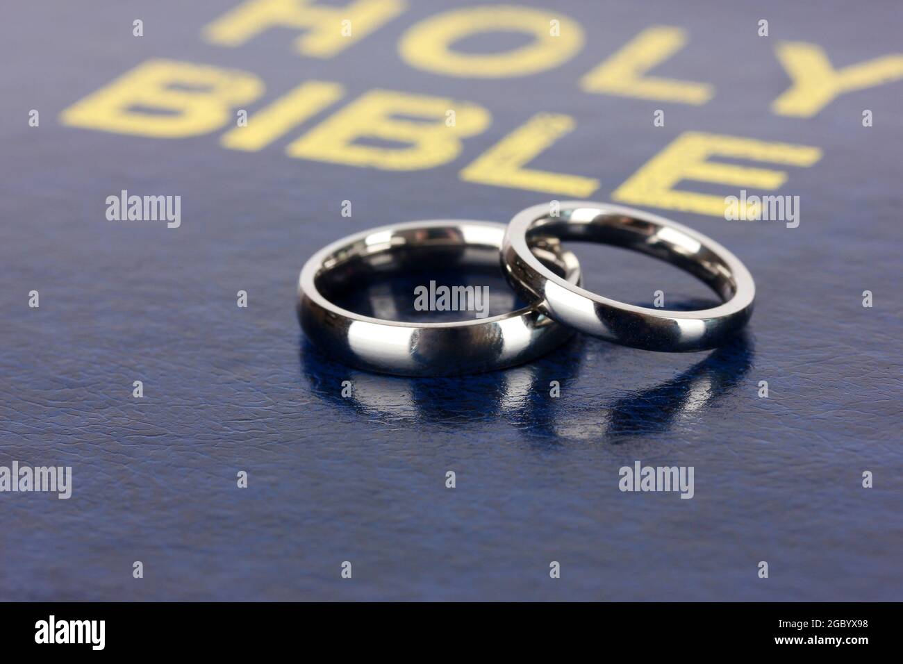 Wedding rings on bible Stock Photo Alamy