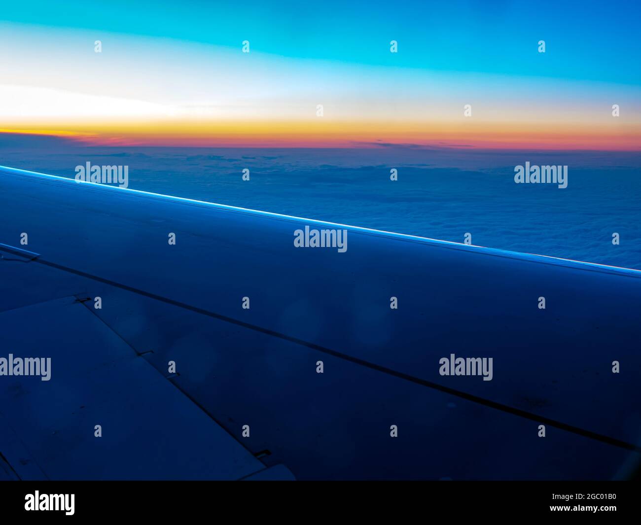 Aerial view above the dark clouds and sky, Inspiration concept. Airliner plane wing view, travel freedom, transport 4k. Passenger airbus flying in clouds, thundercloud, bad rainy weather.  Stock Photo