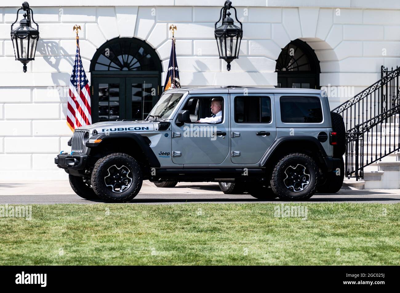 Washington, United States. 05th Aug, 2021. President Joe Biden drives a  Jeep Wrangler Limited Rubicon 4xE around the South Lawn of the White House  at an event where he signed an Executive