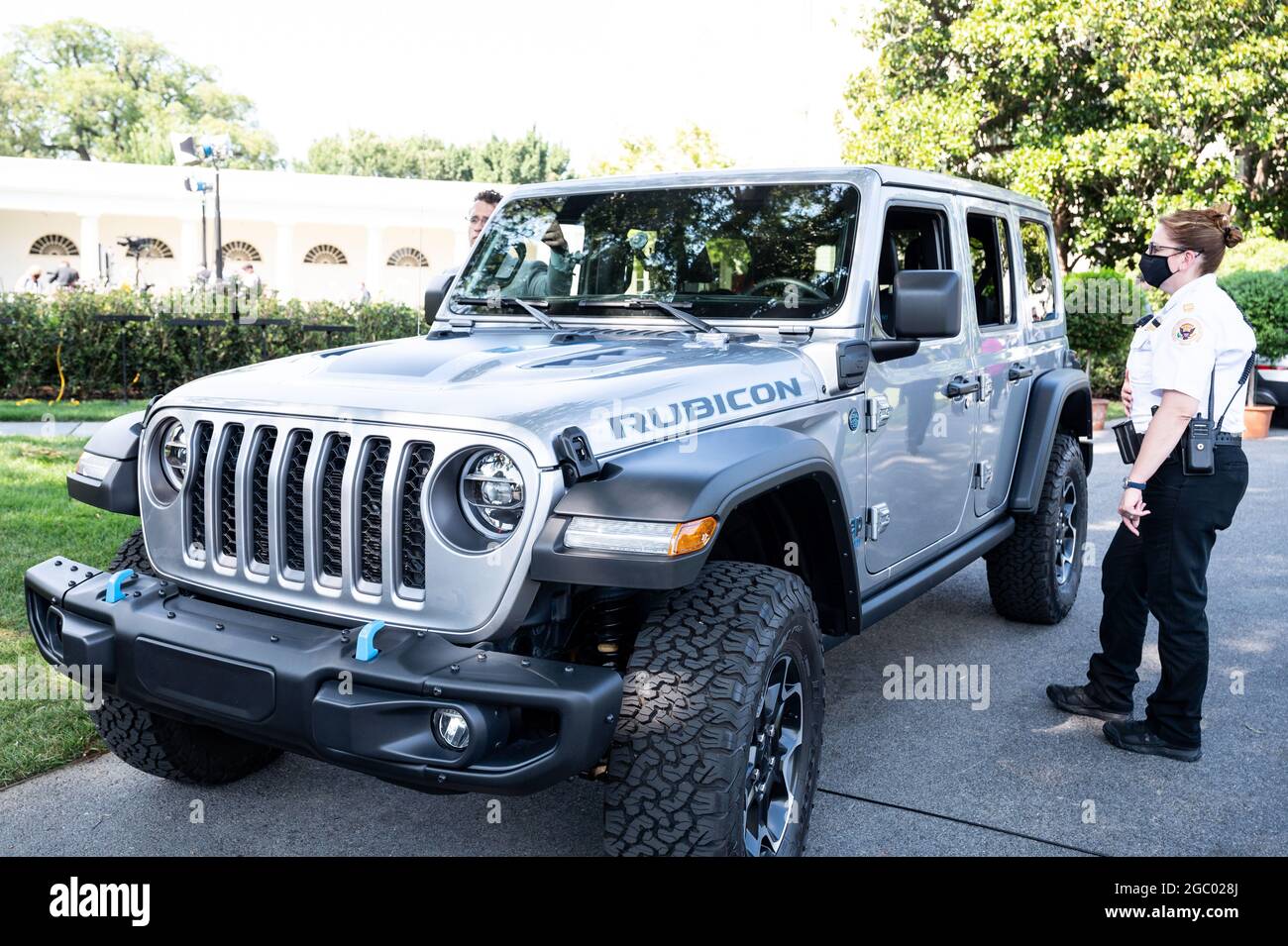 Washington, United States. 05th Aug, 2021. A member of the Secret Service  Uniformed Division looks at a Jeep Wrangler Limited Rubicon 4xE parked near  Rose Garden of the White House at an